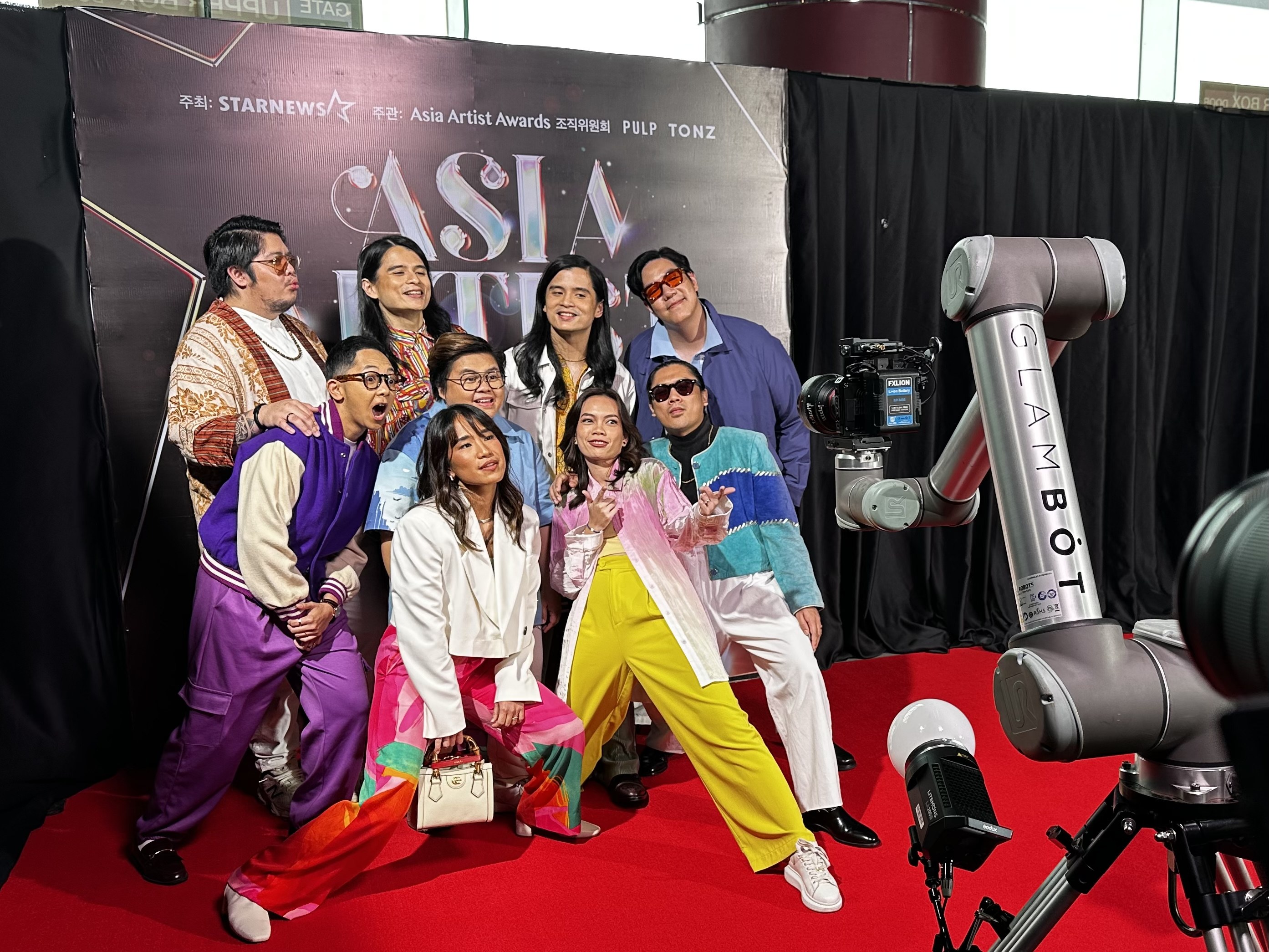 The GlamBot arm on the red carpet with a group of guests posing at the Asia Artist Awards